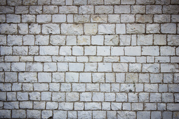 Old natural brown stone blocks wall. Textured background