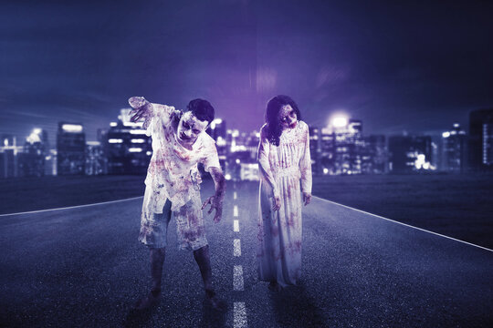 Two spooky zombies walking near glowing city