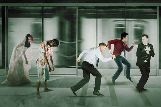 Two Zombies Chasing Businessmen In Train Station