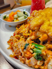 Zoom in Magelangan Food (Noodle mixed with Rice) served with condiment on white plate
