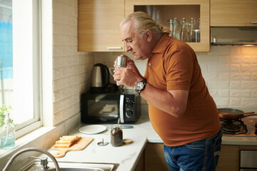 Man Smelling Grounded Coffee