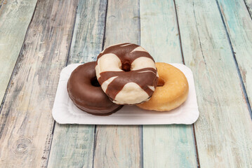 There are many types of donuts: some are glazed with various colors and sometimes they have sprinkles