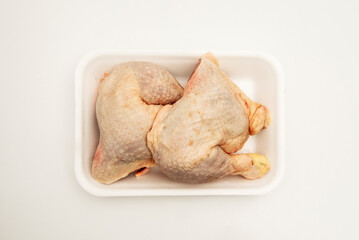 Chopped raw chicken thighs, cleaned and peeled in a white box