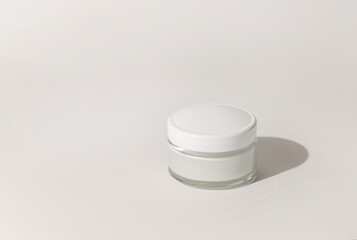 Cosmetic jar with a lid on white close up, mockup. Everyday skincare routine
