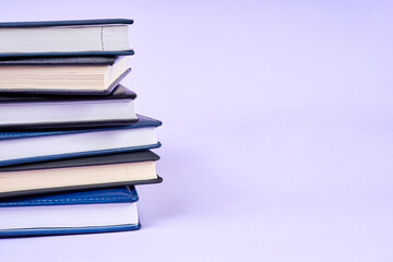 Stack of office notepads on purple background