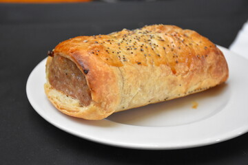 Sausage roll on the white plate