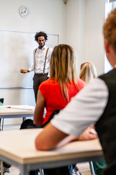 Teenage Students, teacher addressing the class. A candid classroom scene with a form tutor addressing his pupils. From a series of related images.
