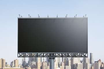 Blank black horizontal billboard on skyline background, front view. Mock up, advertising concept