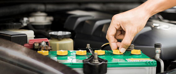 Technicians inspect the car's electrical system.