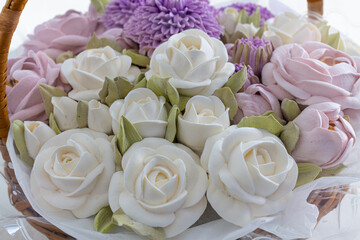 marshmallow bouquet of flowers in a basket on a light background, the concept of the holiday.