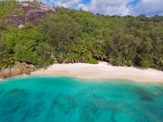 Aerial view from drone of Anse Soleil beach at Mahé Island taken in the afternoon light above the ocean