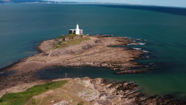 Aerial view of Bracelet Bay the Gower Peninsula South Wales with Mumbles lighthouse, Swansea city,