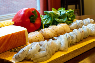 Mise en Place on a Wooden Cutting Board - Shrimp, Scallops, Tomatoes, Spinach, Red Bell Pepper, Fontina Cheese, and Grits 