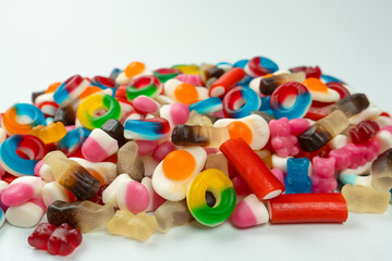 Tasty mix of jelly colorful candies isolated on a white background.