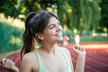 A young woman sportswoman in the summer at the stadium, portrait.