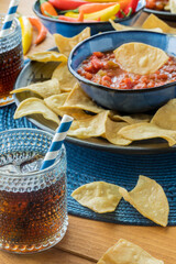 Authentic tortilla chips served with fresh gourmet salsa and soda pop.