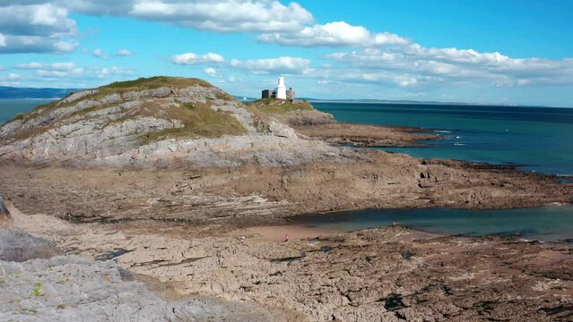 Aerial view of Bracelet Bay the Gower Peninsula South Wales with Mumbles lighthouse, Swansea city,