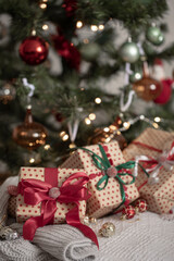 Fototapeta na wymiar Festive gift boxes under the Christmas tree, close-up.