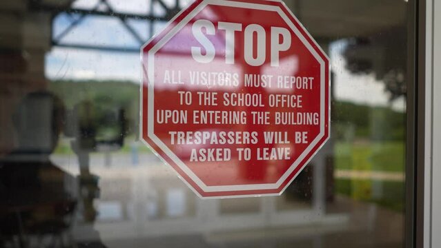 Sign Posted At Entrance To For Their Security And Safety At School Saying That All Visitors Must Report To The Office And Push Button For Entrance.