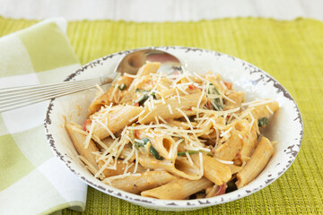 Gluten Free Penne Pasta With Parmesan Cheese In Bowl With Spoon