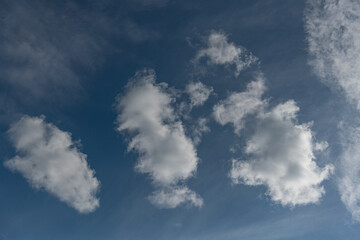 Blue Sky with Three Fluffy Clouds