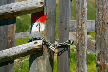 wooden fence with gate on an alpine meadow in südtirol