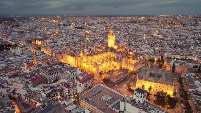 Flying around the famous gothic Cathedral in Seville at night, Andalusia, Spain