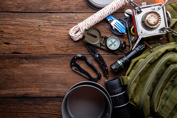 Outdoor travel equipment planning. camping trip on wooden table background.
