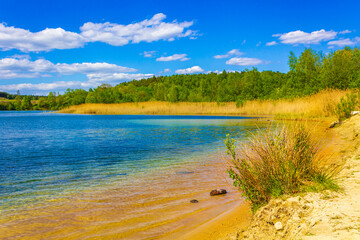 Beautiful quarry lake dredging pond lake blue turquoise water Germany.