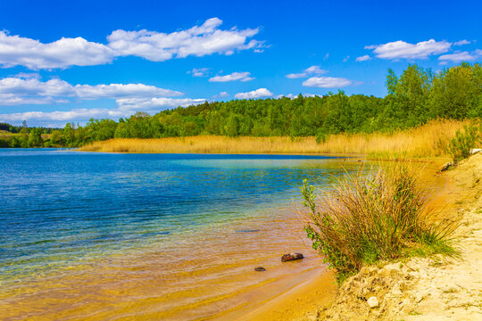 Beautiful quarry lake dredging pond lake blue turquoise water Germany. © arkadijschell