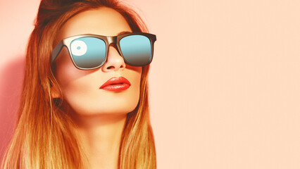 Closeup portrait of fashion woman in sunglasses. Trendy girl in summer style on pink. Eyewear, glasses. Toned photo.