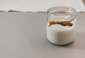 Glass jar with milk. Alternative dairy. Home cooking for vegetarians. Healthy and natural organic nutrition. Lactose free. Vegan plant based milk and ingredients. Close-up, selective focus