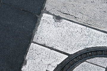 White and dark lines of crossing in the city, closeup, road texture and pattern, grunge pavement background, textured street ground surface.