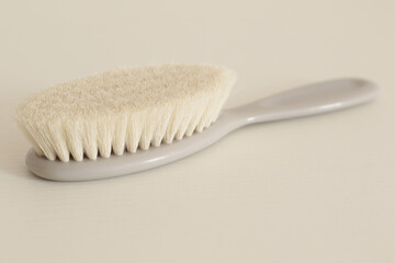 soft grey baby comb on white table