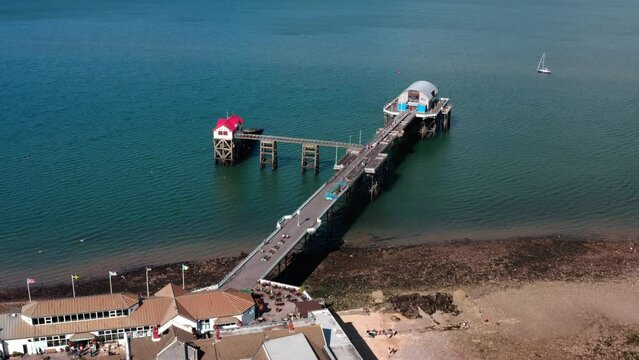 Aerial View of Mumbles Lighthouse and Pier, part of the Gower coastline in South Wales. bright blue waters on a sunny summers day
