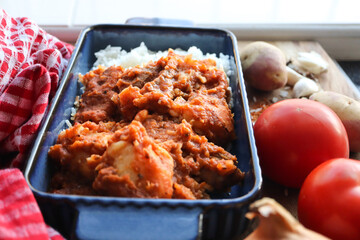 Tomato bredie. A traditional South African cuisine made with tomatoes, lamb and potatoes. With white rice 