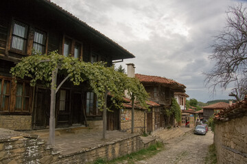 Fototapeta na wymiar Street with traditional wooden houses at the village of Zheravna, Bulgaria