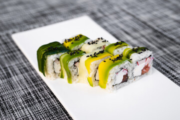 a dish of delicious sushi rolls