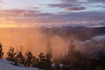 Fototapeta premium sunset over the hillside near Idaho city outside of a yurt during the snowy winter season