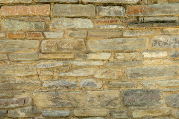 Solid yellow and beige stone wall. Stone background.