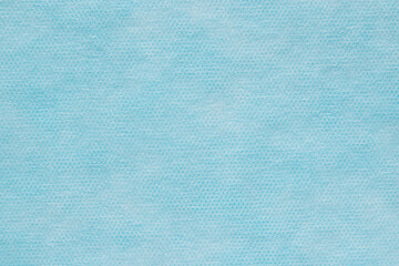 The texture of the surface of blue synthetic fabric. Abstract blank background for wallpaper, soft focus design