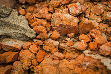 Red brick wall. Remains of a demolished house.