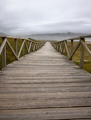 Fototapeta na wymiar Laxe (Spain), August 20, 2022. Wooden footbridge. Footbridge to cross the dunes of Traba beach.