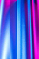 Neon hues over corrugated magenta and blue background. Futuristic abstract backdrop