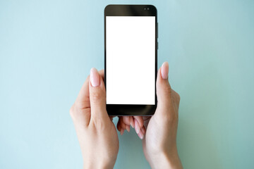Online schedule. Mobile mockup. Digital technology. Female hands holding smartphone with white blank screen isolated blue background.
