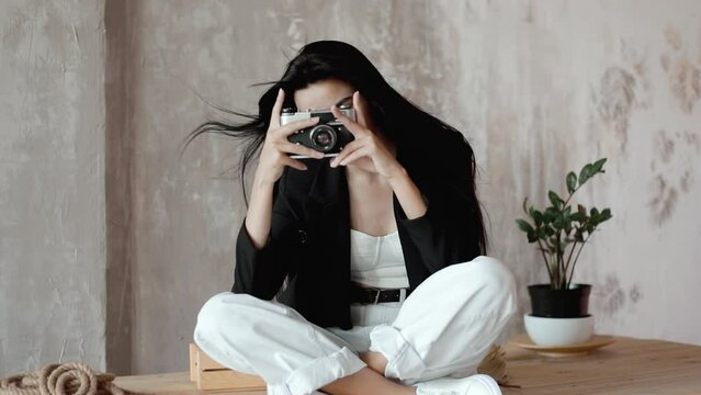 Oriental Young girl shoots happy moments with a camera. photographer taking pictures