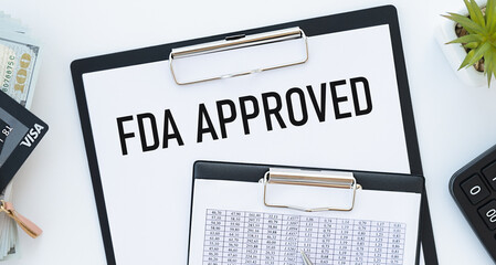 Stickers with pencils and notebook with text FDA APPROVED ona chart background