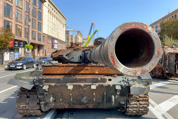 Russian battle tank knocked and destroyed during war Ukraine against Russian aggression are showing to people, on Khreshchatyk in Kyiv. Selective focus. - 524913890