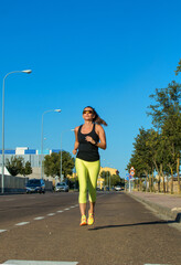 Beautiful young woman exercising for her daily workout. Mature woman running. Healthy lifestyle