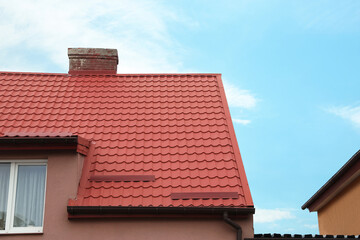 Beautiful house with red roof against blue sky